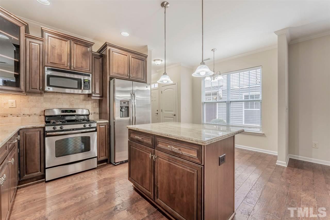 2431 Swans Rest Way Raleigh, NC 27606 - Photo 5 of 25 a kitchen with a sink stove and refrigerator