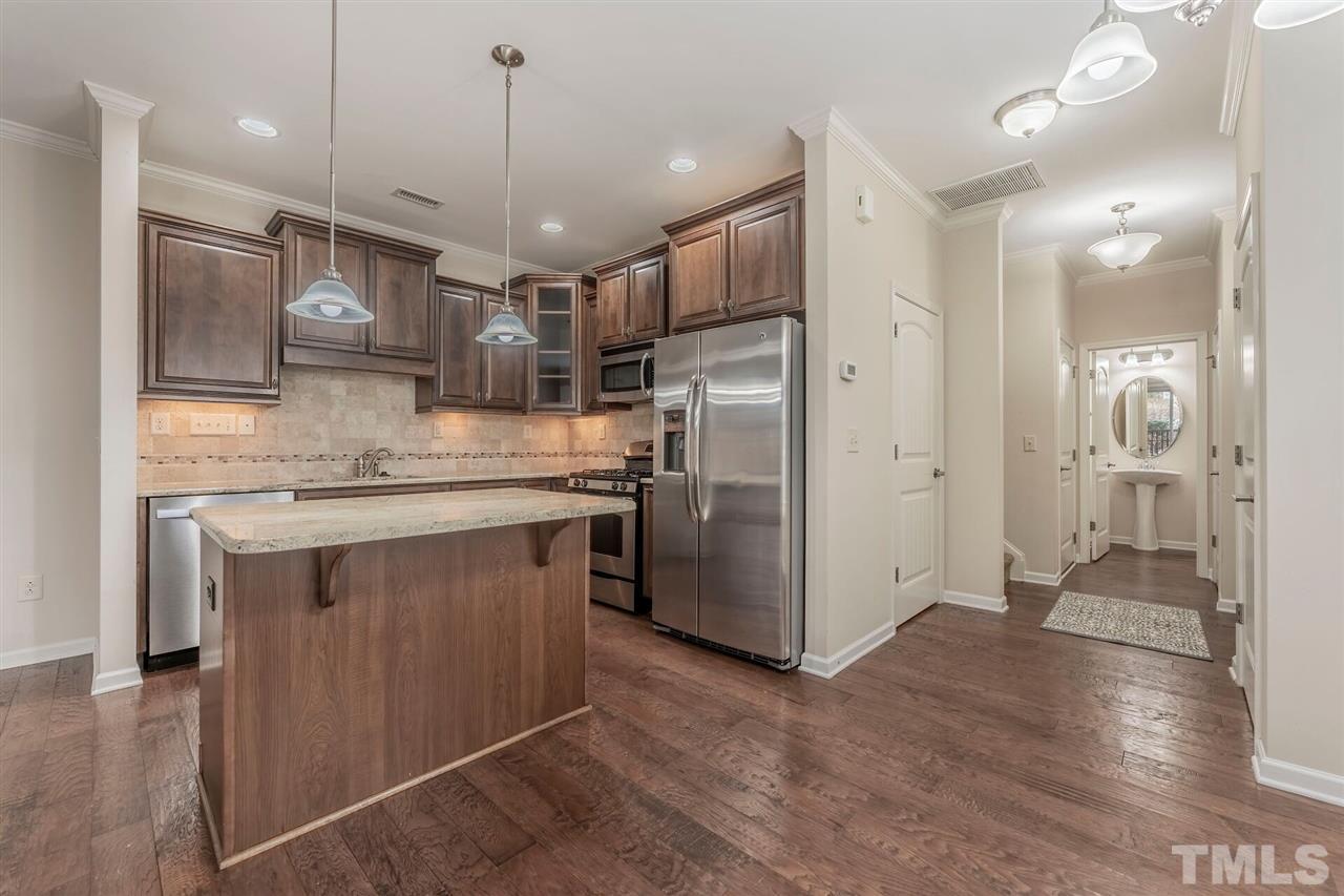 2431 Swans Rest Way Raleigh, NC 27606 - Photo 8 of 25 a kitchen with stainless steel appliances granite countertop a refrigerator a sink and a stove