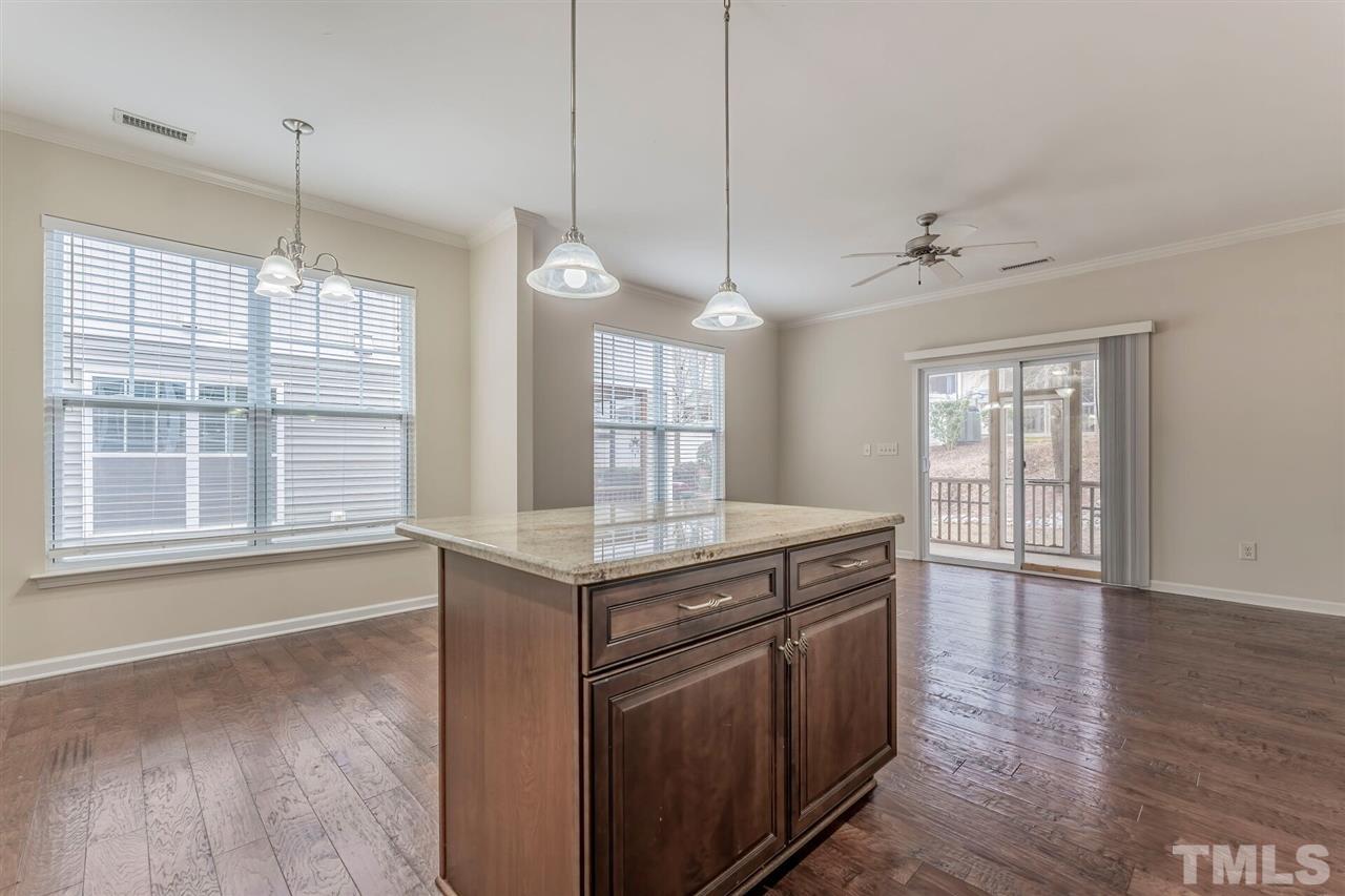 2431 Swans Rest Way Raleigh, NC 27606 - Photo 10 of 25 a kitchen with stainless steel appliances granite countertop a stove a sink and wooden floor
