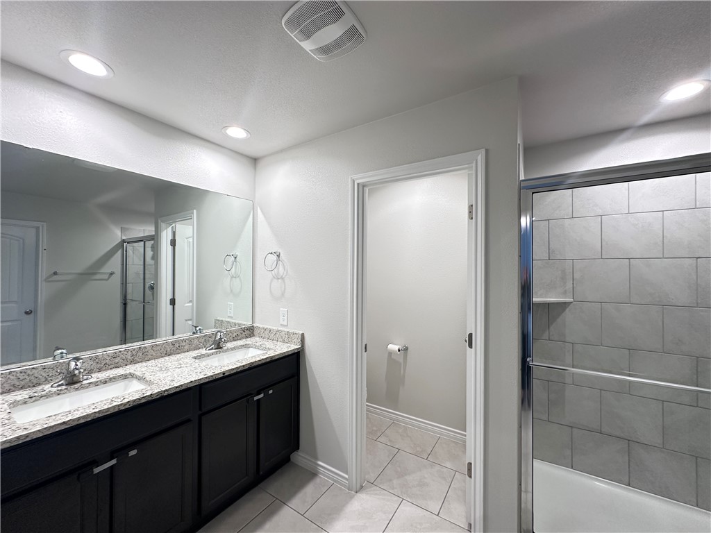 7649 Herd Rider Lane Corpus Christi, TX 78414 - Photo 8 of 18 a bathroom with a double vanity sink and mirror