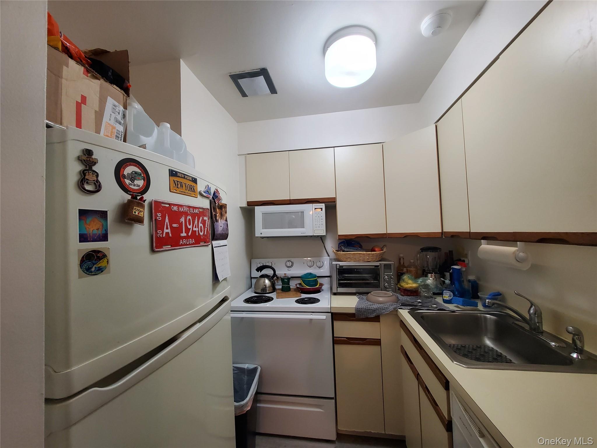 360 Shore Road, Unit 5A Long Beach, NY 11561 - Photo 8 of 16 a kitchen with stainless steel appliances granite countertop a sink and cabinets