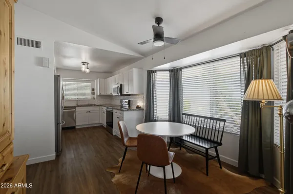 a kitchen with granite countertop stainless steel appliances a refrigerator sink and cabinets