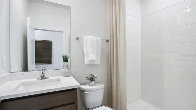 a bathroom with a toilet a sink and a mirror
