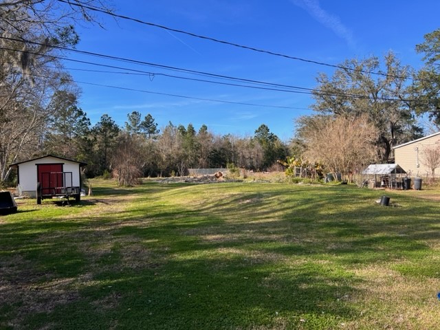 96735 Blackrock Road Yulee, FL 32097 - Photo 5 of 46 a swimming pool with wooden fence