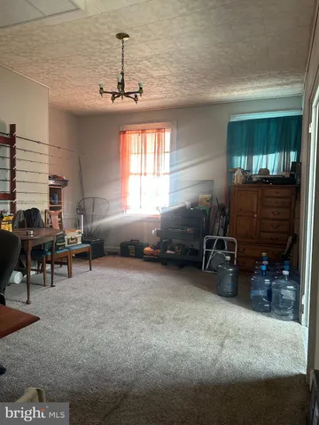 a living room with furniture a window and gym equipment