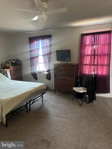 a bedroom with furniture and a flat screen tv