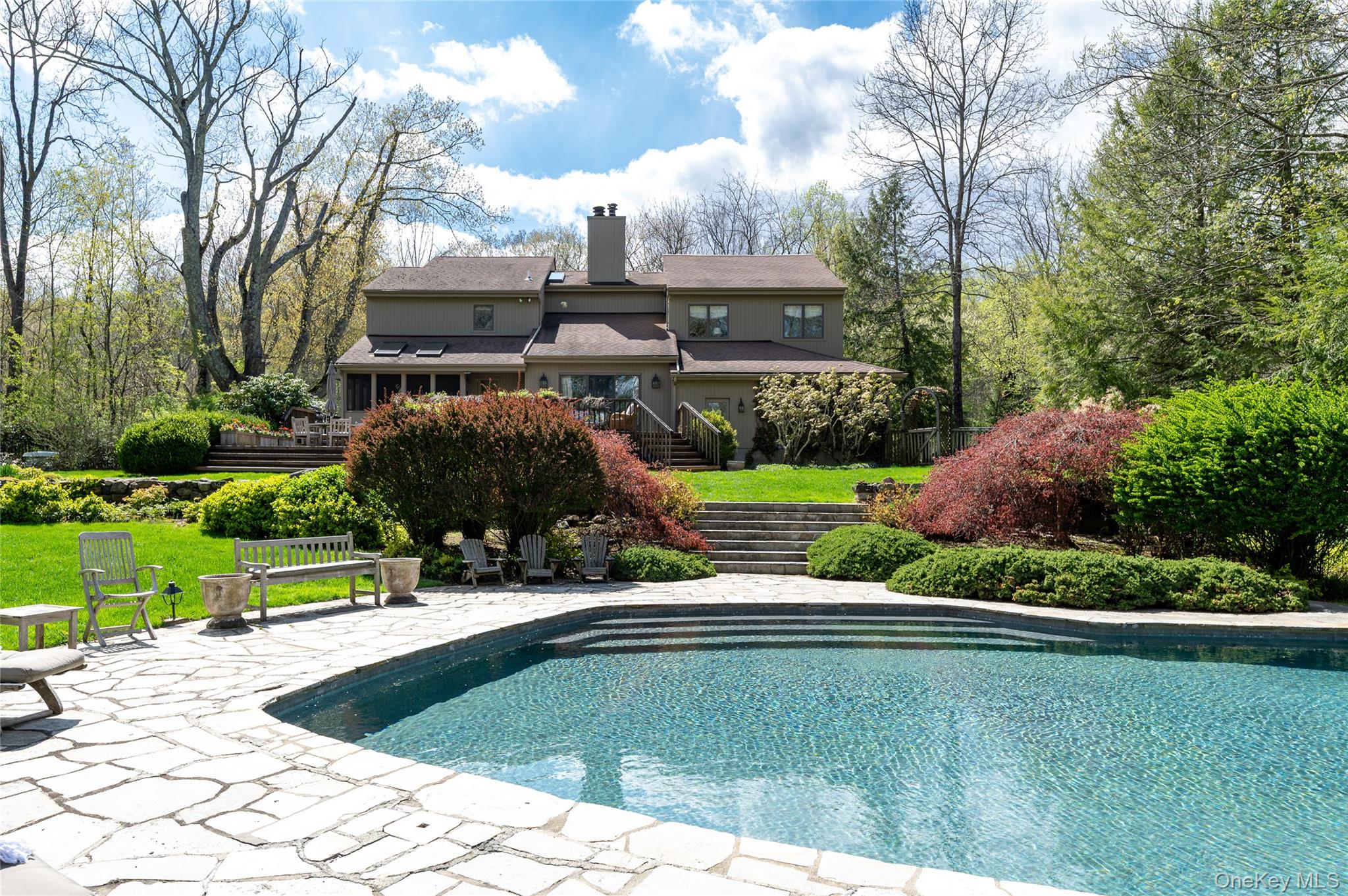 Back view of the house with spectacular pool and stone terracing