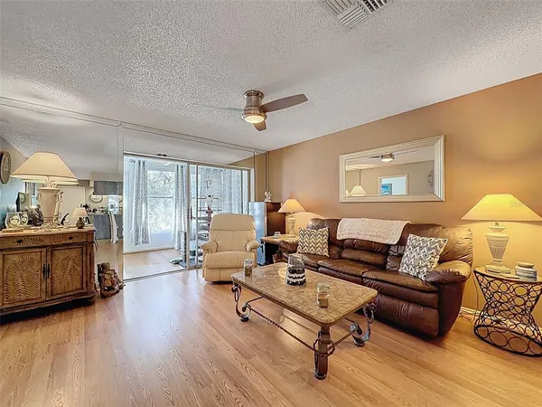 a living room with furniture and a wooden floor