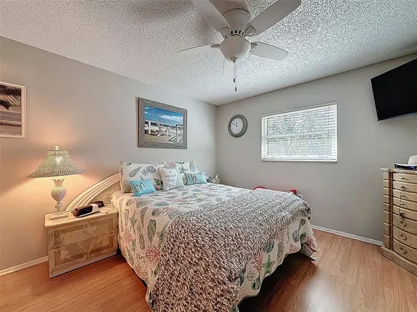 a bedroom with a large bed and a flat screen tv