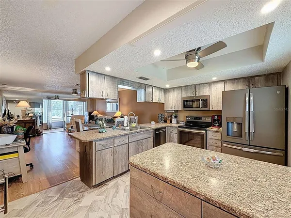 a kitchen with a sink a stove and cabinets