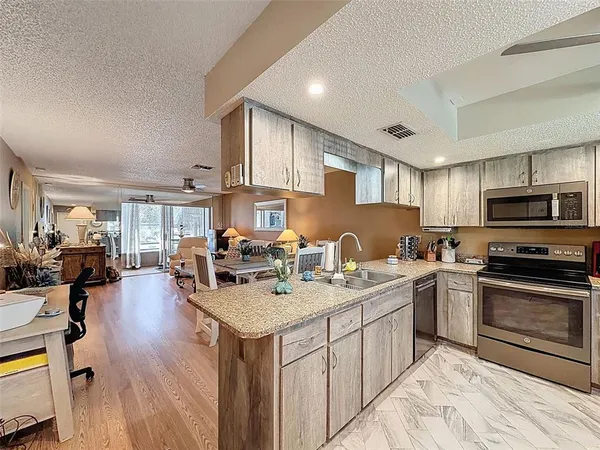 a view of a livingroom with furniture hardwood floor and workspace