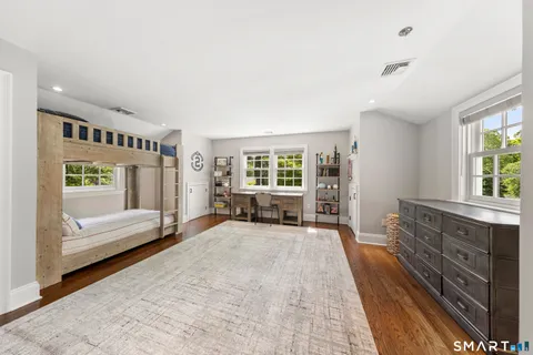 a spacious bedroom with a large bed and a window