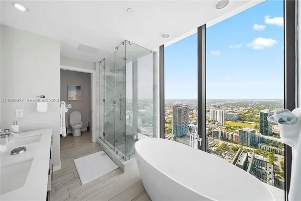 a large white room with a large window and a bathtub