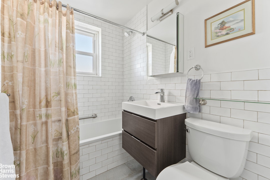 11 Riverside Drive, Unit 9DEW Manhattan, NY 10023 - Photo 7 of 20 a bathroom with a sink toilet and shower