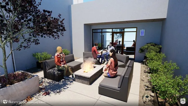 a living room with furniture and a potted plant