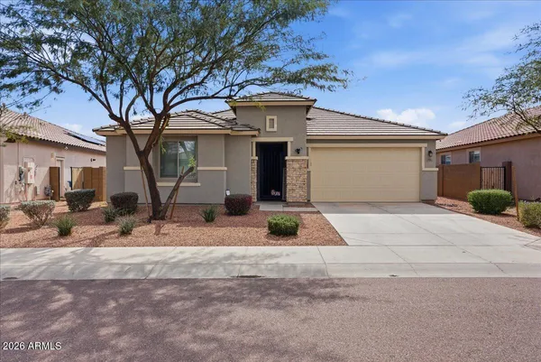 a front view of a house with a yard and garage