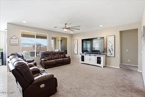 a living room with furniture kitchen and a chandelier