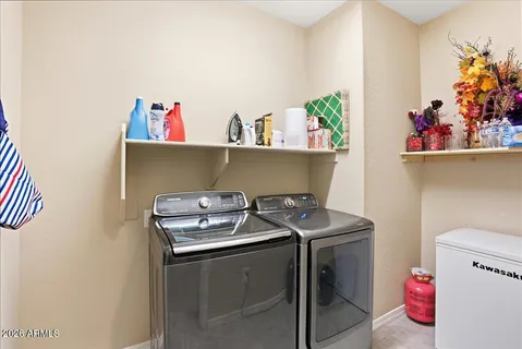 a hallway with dining room and chandelier
