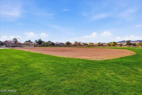 a patio with a table and chairs under an umbrella