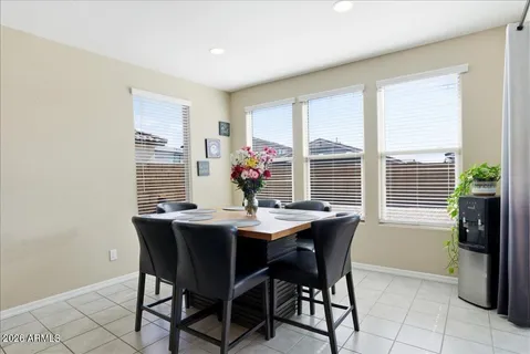 a kitchen with granite countertop a table chairs in it and wooden floors