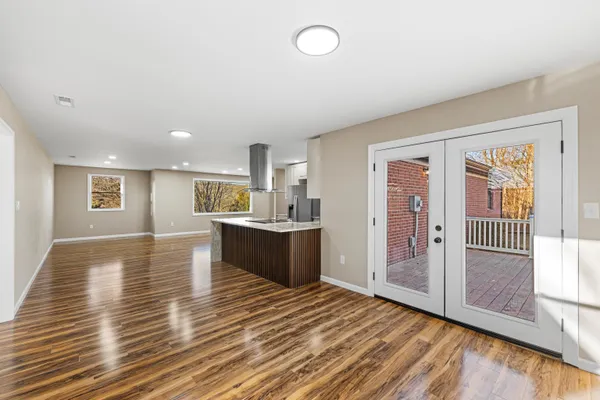 a view of a room with wooden floor and windows