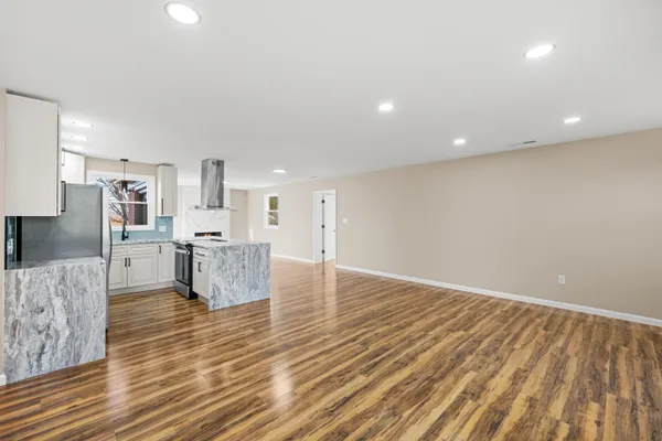 a kitchen with granite countertop white cabinets and a sink