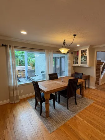 a view of a dining room with furniture window and wooden floor