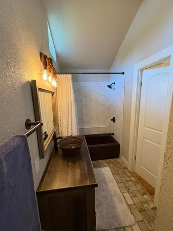 a bathroom with a sink a mirror and a shower