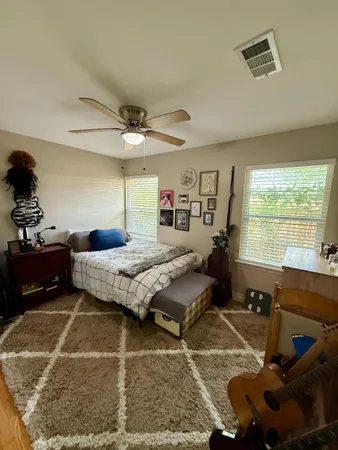 a bedroom with a bed and wooden floor