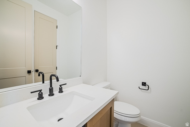 223 South Cottonwood Road, Unit 7501 Vineyard, UT 84059 - Photo 45 of 45 Modern bathroom featuring a wood-finish vanity, a rectangular integrated sink, and matte black fixtures