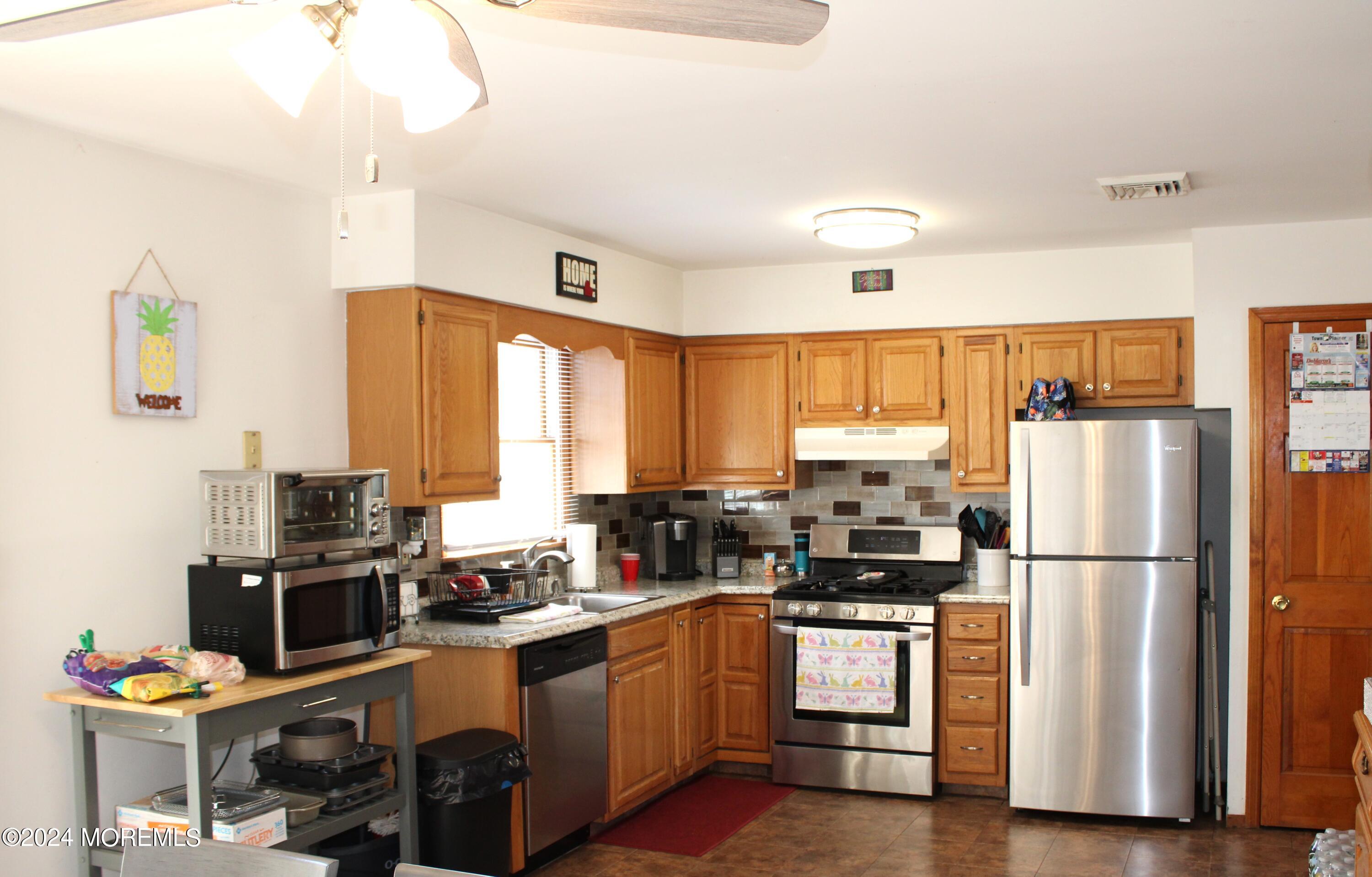 97 County Road Cliffwood, NJ 07721 - Photo 11 of 24 a kitchen with granite countertop a refrigerator stove top oven and sink