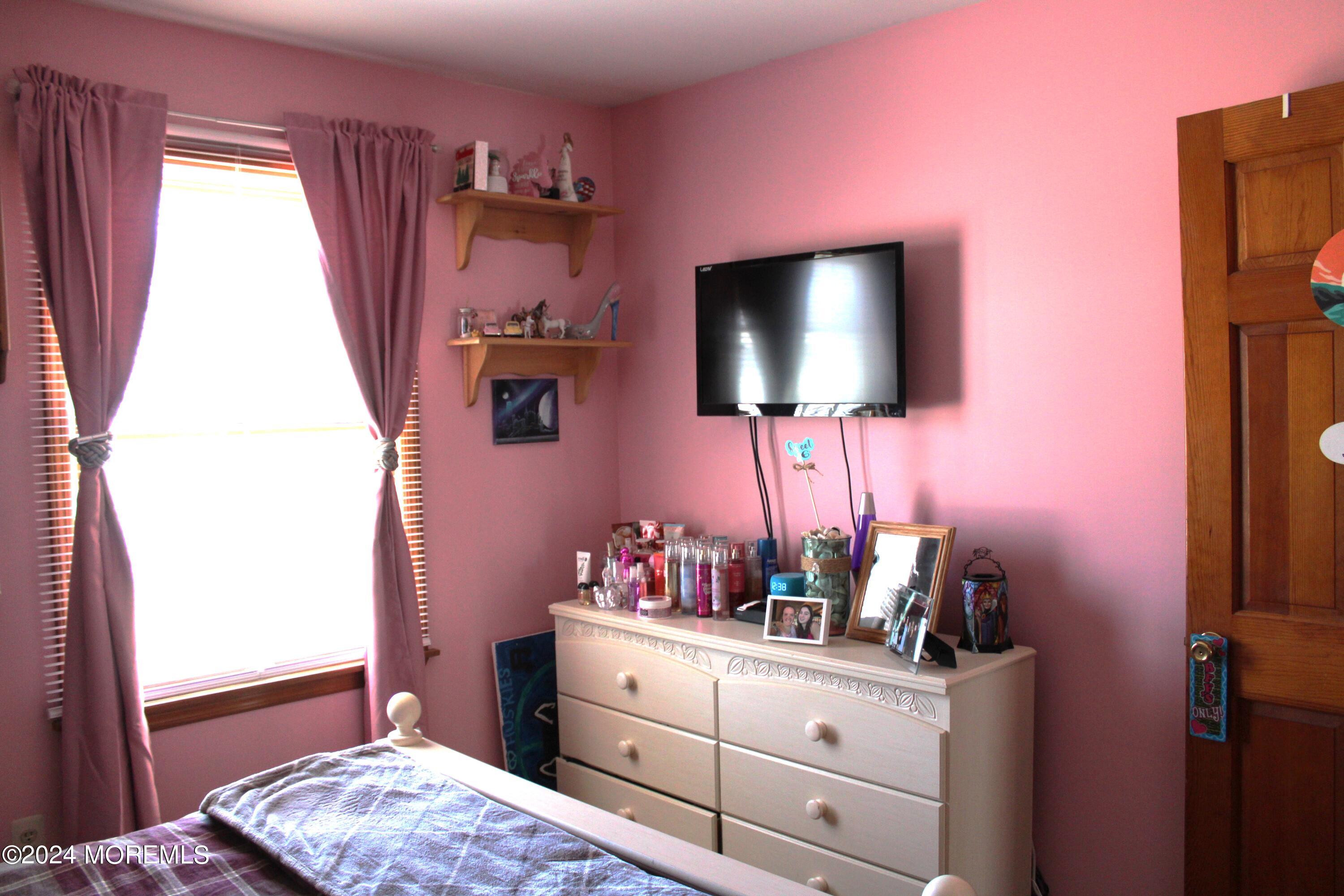 97 County Road Cliffwood, NJ 07721 - Photo 18 of 24 a bedroom with a bed and a flat screen tv