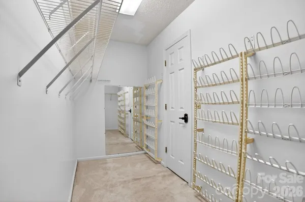 a view of a hallway with wooden floor and windows