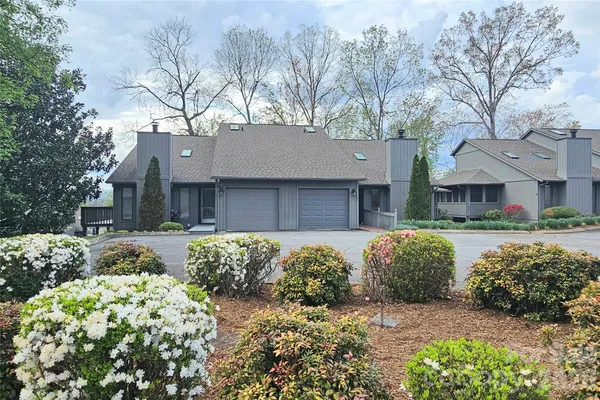 a view of a house with a yard and deck