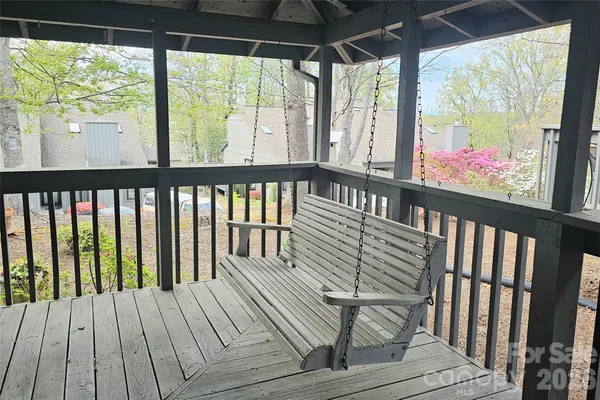a view of an empty room with wooden floor fireplace and a window