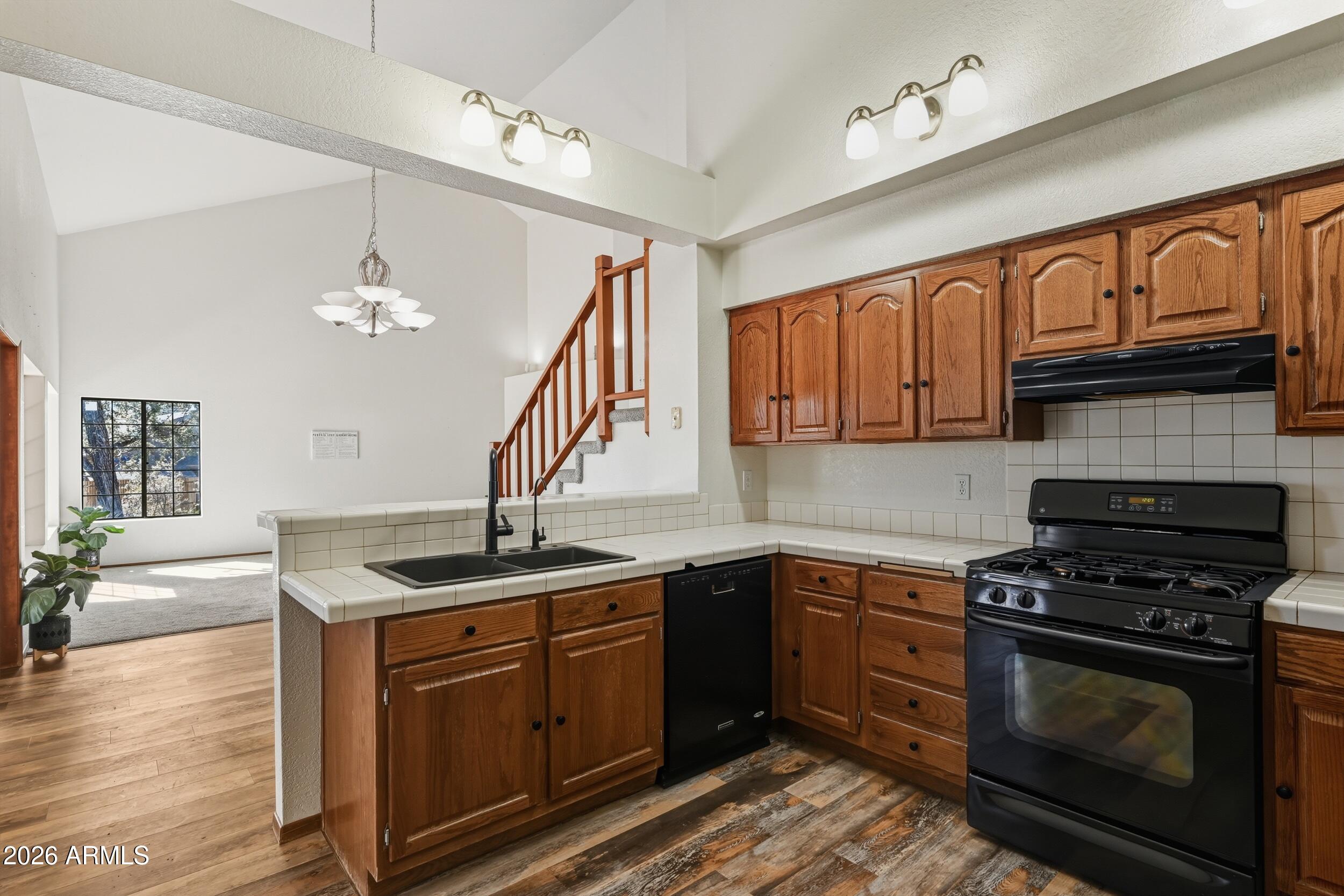 1101 North McLane Road Payson, AZ 85541 - Photo 13 of 65 a kitchen with stainless steel appliances granite countertop a sink stove and cabinets