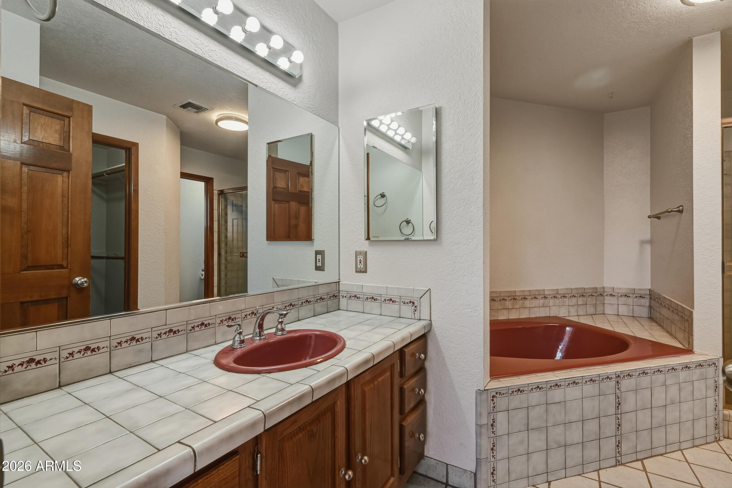 1101 North McLane Road Payson, AZ 85541 - Photo 19 of 65 a bathroom with a sink and a mirror