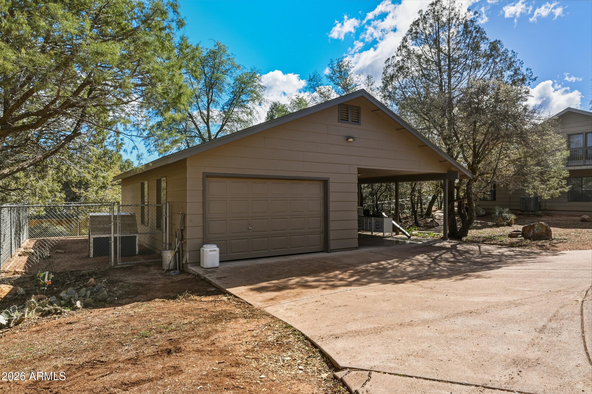 1101 North McLane Road Payson, AZ 85541 - Photo 37 of 65 a front view of a house with a yard and garage