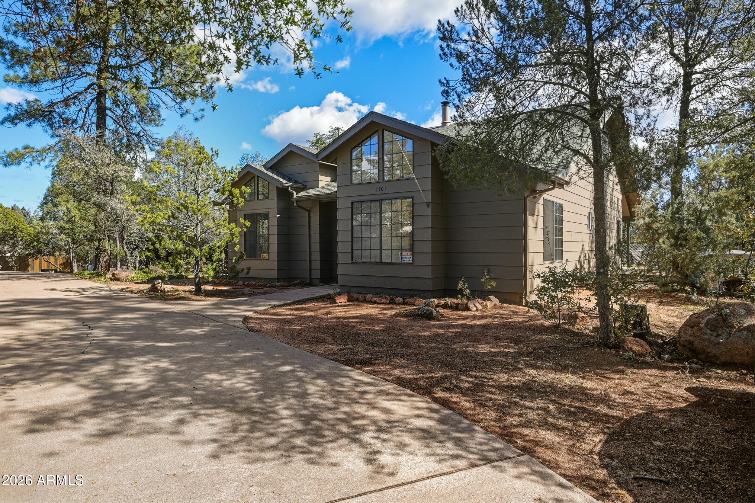 1101 North McLane Road Payson, AZ 85541 - Photo 5 of 65 a front view of a house with a yard and garage