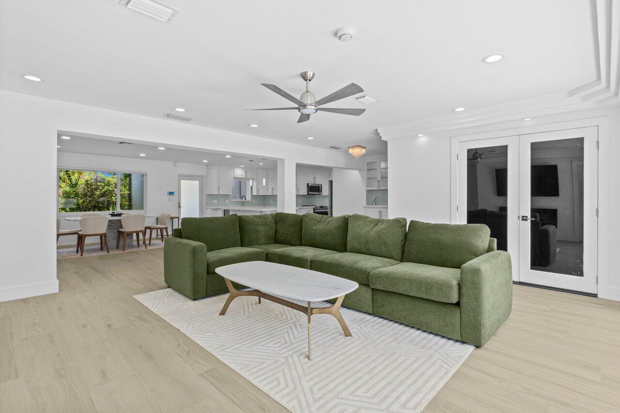 2611 Northeast 49th Street Lighthouse Point, FL 33064 - Photo 19 of 56 a living room with furniture ceiling fan and a rug