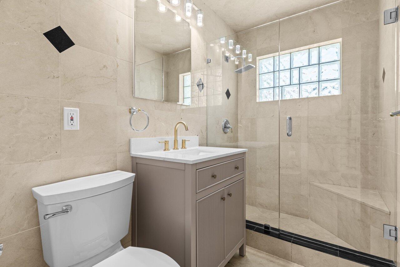 2611 Northeast 49th Street Lighthouse Point, FL 33064 - Photo 22 of 56 a bathroom with a sink toilet and shower