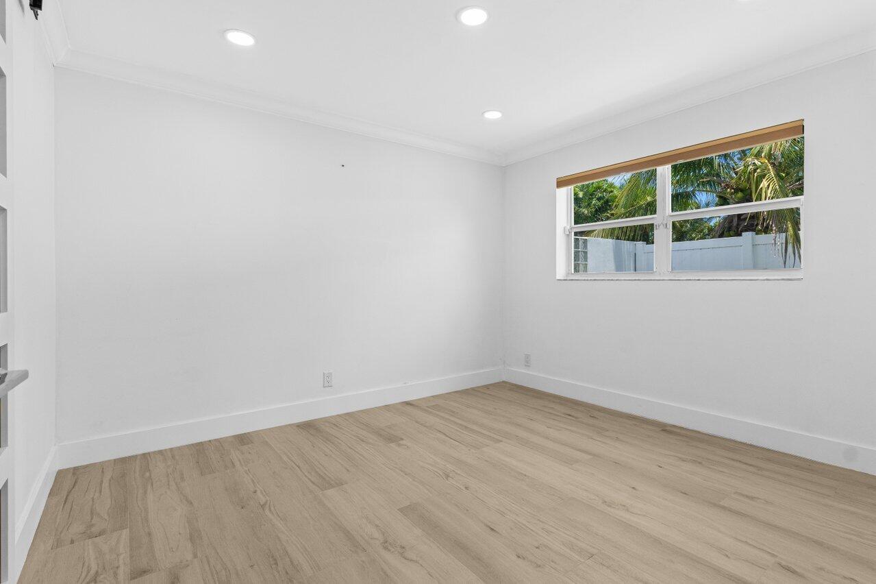 2611 Northeast 49th Street Lighthouse Point, FL 33064 - Photo 23 of 56 an empty room with a window