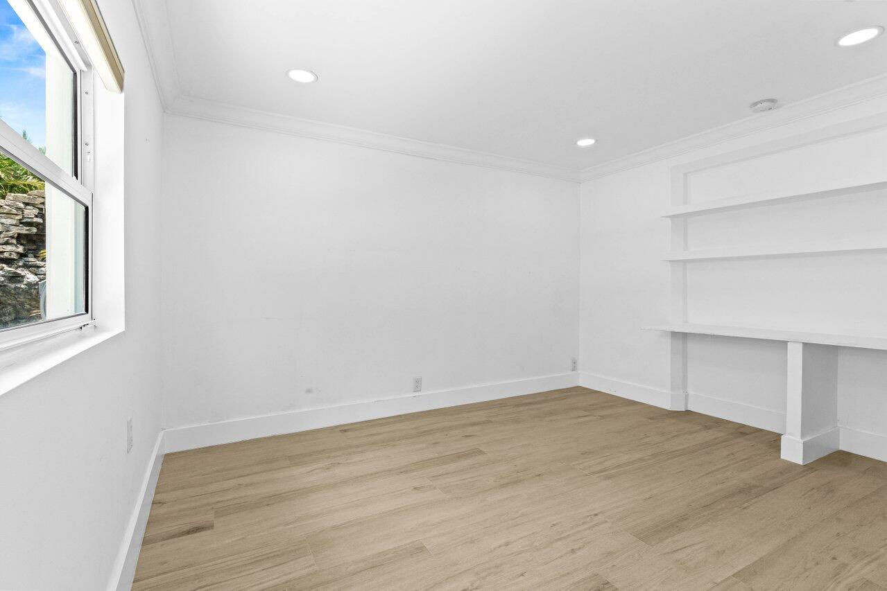 2611 Northeast 49th Street Lighthouse Point, FL 33064 - Photo 25 of 56 wooden floor in an empty room with a window