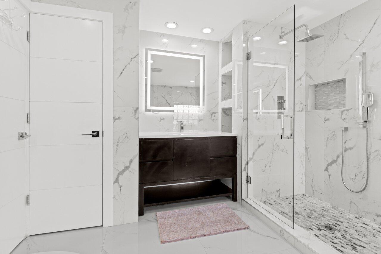 2611 Northeast 49th Street Lighthouse Point, FL 33064 - Photo 32 of 56 a bathroom with a shower and a sink