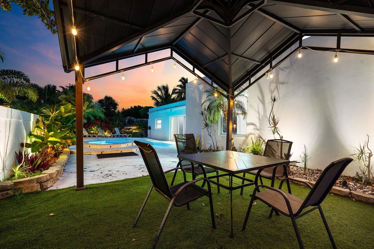 2611 Northeast 49th Street Lighthouse Point, FL 33064 - Photo 56 of 56 a view of an outdoor space with a table and chairs