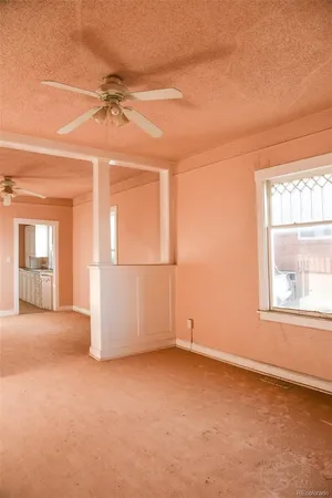an empty room with windows and closet