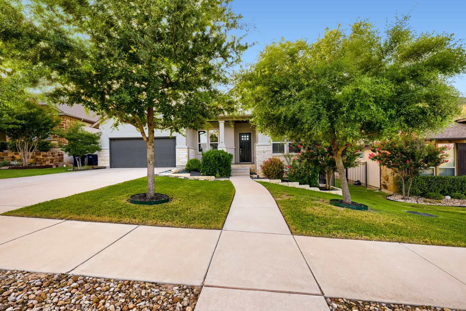 621 Rancho Sienna Loop Georgetown, TX 78628 - Photo 1 of 28 A graceful sidewalk guides the eye to this appealing home with a well-maintained lawn and mature trees.
