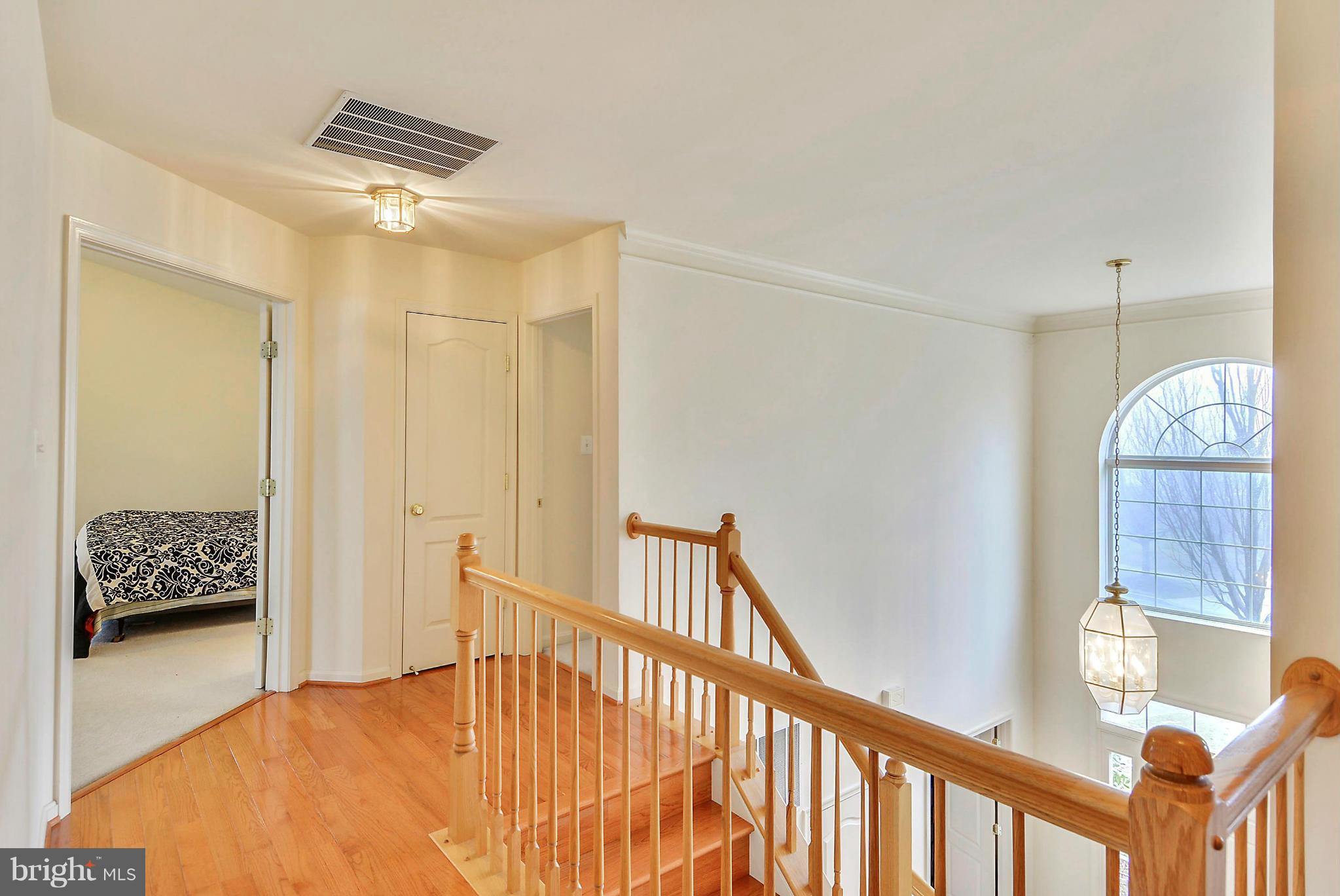 17904 Coachmans Road Germantown, MD 20874 - Photo 14 of 30 Upstairs Hallway with Hardwood Floor