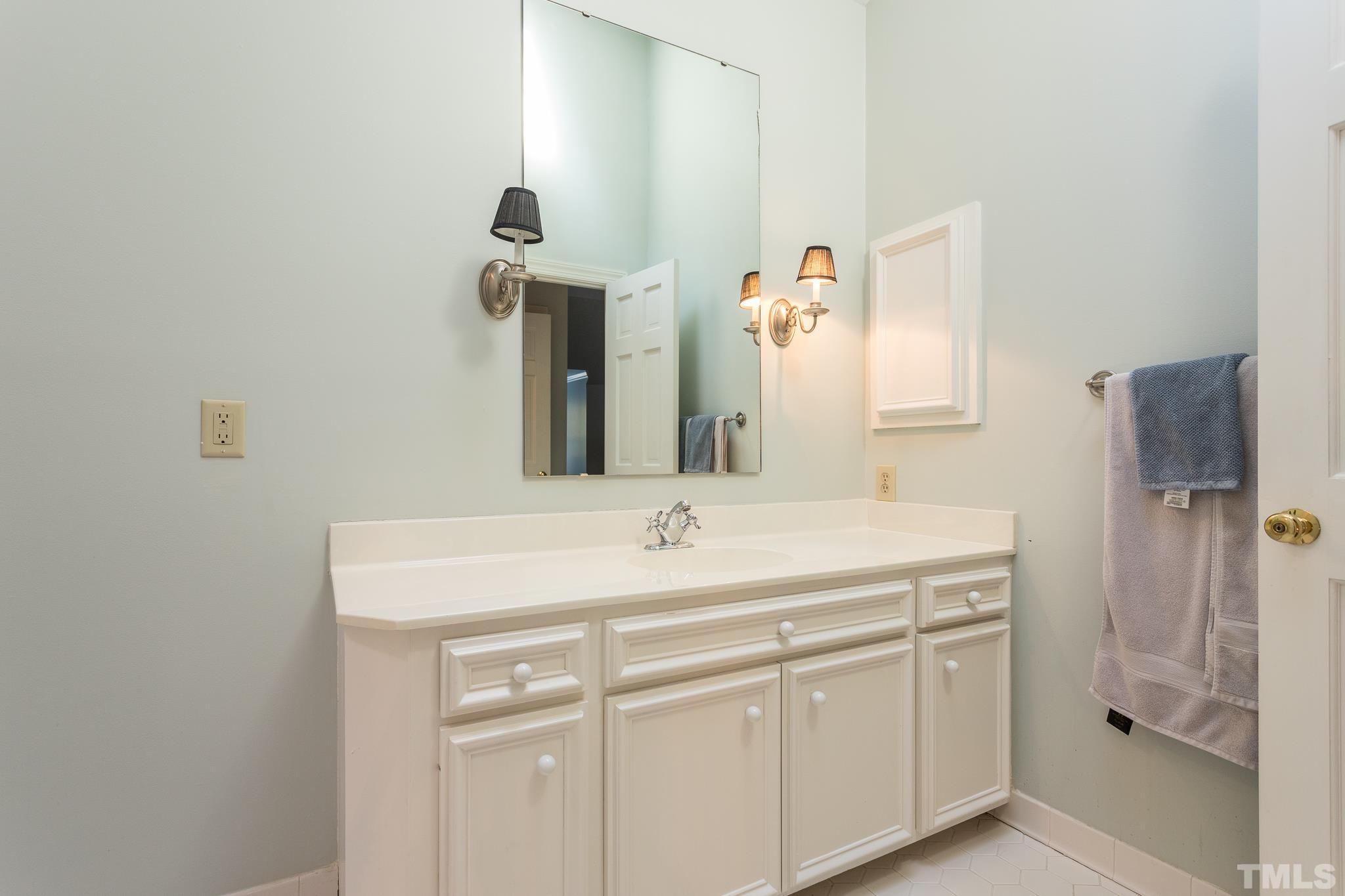 2505 Winterbury Court Raleigh, NC 27607 - Photo 22 of 24 a bathroom with a sink and a mirror