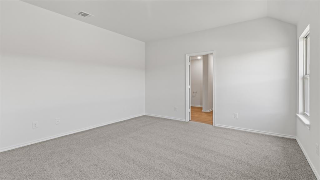 1913 Reveille Way Terrell, TX 75160 - Photo 15 of 35 Unfurnished room with light carpet and lofted ceiling